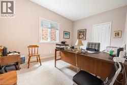Kitchen featuring extensive white cabinetry, stainless steel appliances, and light-toned countertops - 