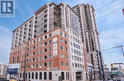 Contemporary high-rise building featuring a brick and stone facade, expansive window walls, multiple balconies, and street-level commercial spaces - 