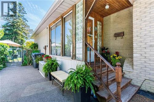 Front entry featuring wood-paneled stairs and a glass block window - 1293 Daimler Road, Mississauga, ON 