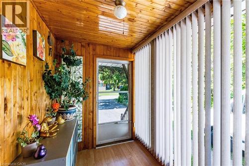 Sunroom featuring extensive wood paneling on walls and ceiling - 1293 Daimler Road, Mississauga, ON 