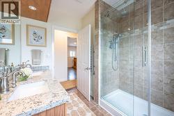 4-piece main bath with dual vanities and tiled shower - 