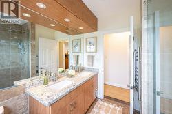 4-piece main bath with dual vanities and tiled shower - 
