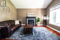 Living room with hardwood floors and gas fireplace - 