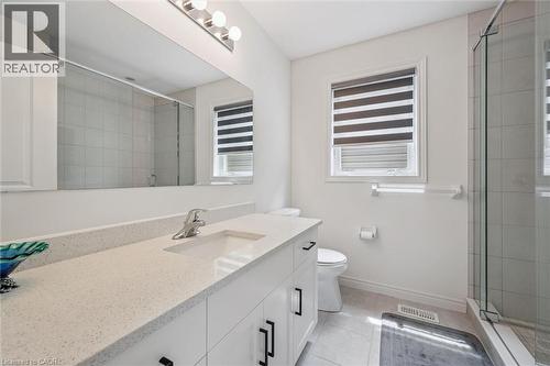 Bathroom featuring a vanity with an integrated sink, a speckled countertop, and white cabinetry with black hardware - 153 Rivertrail Avenue, Kitchener, ON - Indoor Photo Showing Bathroom
