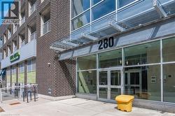Modern building entrance featuring a glass canopy and prominent numerical signage - 