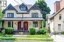 Brick exterior with dark trim and complementary red doors - 67 Ahrens Street W, Kitchener, ON 