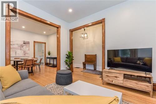 Hardwood-finish flooring extends through multiple open archways - 67 Ahrens Street W, Kitchener, ON 