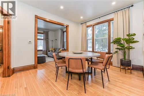 Hardwood flooring throughout featuring recessed lighting, extensive wood trim, and large windows - 67 Ahrens Street W, Kitchener, ON 