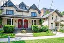 Brick exterior featuring contrasting dark trim and a covered front porch - 67 Ahrens Street W, Kitchener, ON 