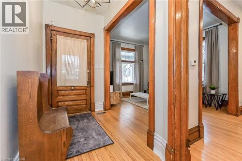 Hardwood flooring throughout the entryway and visible rooms - 67 Ahrens Street W, Kitchener, ON 