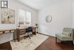 Office area featuring baseboards and dark wood-type flooring - 