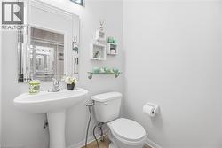 Bathroom featuring toilet and baseboards - 