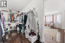 Walk in closet featuring dark wood-type flooring - 