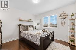 Bedroom featuring dark wood-style floors - 