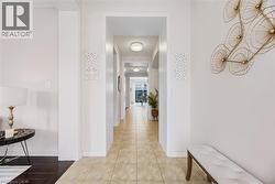 Hallway featuring light tile patterned flooring - 
