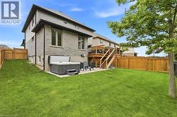 Expansive green lawn with a wooden privacy fence - 