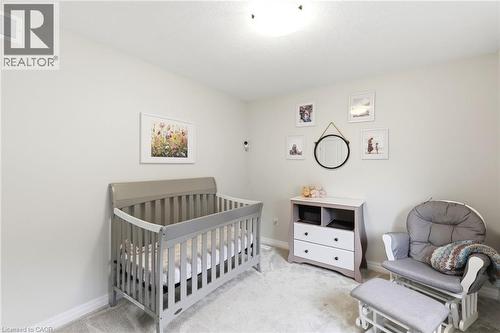 Bright interior space featuring light-colored walls and carpet flooring - 39 Dunning Way, St. Thomas, ON 
