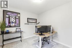 Room featuring light-colored walls, recessed lighting, and soft gray carpeting - 