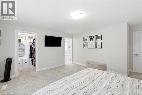 Carpeted room featuring light gray walls, white trim, and a flush-mount ceiling light - 39 Dunning Way, St. Thomas, ON 