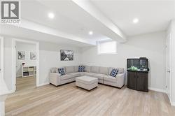 Spacious room featuring light wood-finish flooring, recessed lighting, and a window with blinds - 