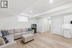 Finished lower level featuring light wood-finish flooring - 