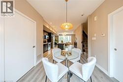Open concept living area featuring wood-finish flooring and recessed lighting - 