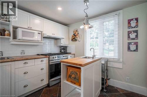 Functional kitchen area with second sink in island. - 99 Argyle Street N, Caledonia, ON 