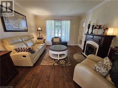 Living room features engineered hardwood and fireplace - 120 Lynndale Road, Simcoe, ON 