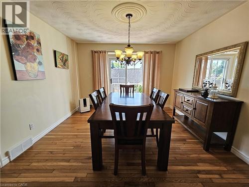Dining area features bruce hardwood floors and patio doors to deck - 120 Lynndale Road, Simcoe, ON 