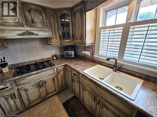 Dual-basin sink with a gooseneck faucet and California shutters - 120 Lynndale Road, Simcoe, ON 