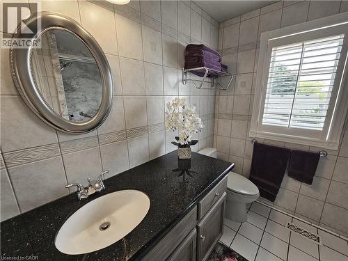 Bathroom vanity with granite countertop, undermount sink and chrome faucet - 120 Lynndale Road, Simcoe, ON 