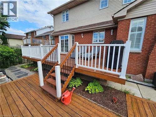 Multi-tier wood deck with white railings and black balusters - 120 Lynndale Road, Simcoe, ON 