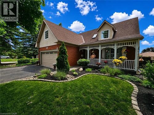 Beautiful curb appeal with covered front porch and manicured gardens - 120 Lynndale Road, Simcoe, ON 