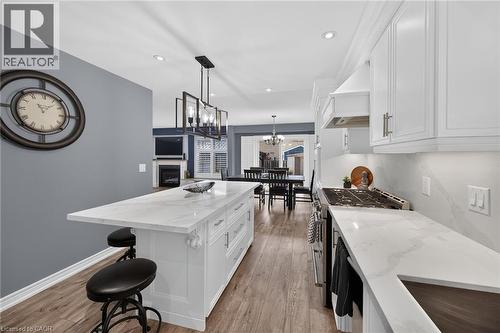 Spacious room featuring rich wood-finish flooring, light gray walls, and white trim - 43 Wilbur Drive, Binbrook, ON 