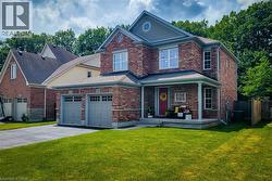 Traditional two-story brick exterior with a prominent front porch - 