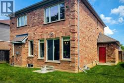 Brick exterior featuring multiple windows and a sliding glass door - 