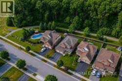 Residential street with brick and siding homes, each featuring attached garages and private driveways - 