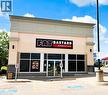 Commercial storefront featuring a neutral-toned facade with a dark stone-look base - 457 Wharncliffe Road S, London, ON 
