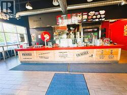 Commercial service counter with a red countertop and wood-finish paneling - 