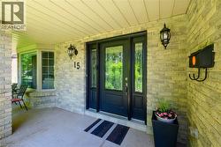 Brick exterior facade featuring a black paneled entry door with decorative glass inserts and matching sidelights - 