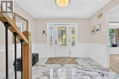 Entryway featuring white wainscoting and large format marble-look tile flooring - 15 Cheval Drive, Grimsby, ON - Indoor Photo Showing Other Room