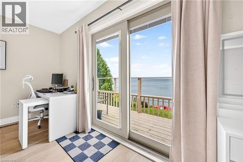 Sliding glass doors opening to a wood deck, offering broad water views - 15 Cheval Drive, Grimsby, ON - Indoor