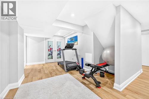 Versatile lower-level space featuring light wood-finish flooring, recessed lighting, and white baseboards - 15 Cheval Drive, Grimsby, ON - Indoor Photo Showing Gym Room