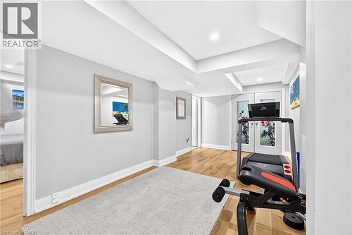 Versatile room featuring wood-finish flooring, recessed lighting, and white baseboards - 15 Cheval Drive, Grimsby, ON - Indoor
