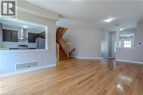 Open-concept living area featuring light wood-finish flooring throughout - 3896 Tufgar Crescent, Burlington, ON 