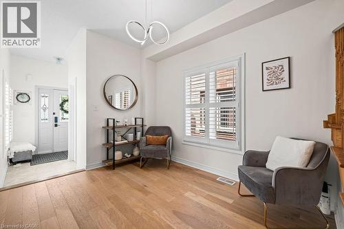 Bright entry area featuring light wood-finish flooring, white walls, and a modern ceiling fixture - 4670 Thomas Alton Boulevard, Burlington, ON 