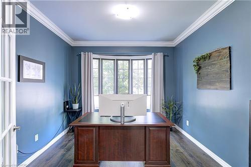 Bay window with natural light, wood-finish flooring, French doors, crown molding, and a central ceiling light fixture - 1406 Marshall Crescent, Milton, ON 