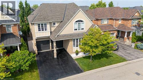 Two-story residence featuring a combination of brick and stucco siding - 1406 Marshall Crescent, Milton, ON 
