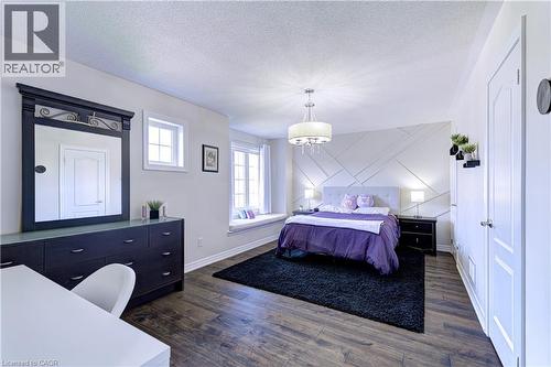 Spacious interior featuring wood-finish flooring, a decorative accent wall, and a built-in window seat - 1406 Marshall Crescent, Milton, ON 