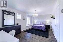 Spacious interior featuring wood-finish flooring, a decorative accent wall, and a built-in window seat - 